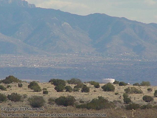 The water tower and city in the distance towards the Sandia Mountain from this 0.88 acre property for sale in Rio Rancho, New Mexico. This property sits just off Rainbow Boulevard only 2 units NW of the new city center!